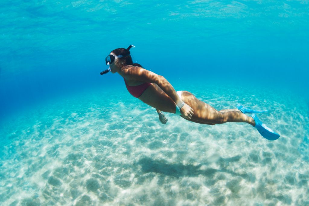 A woman snorkeling in tropical sea