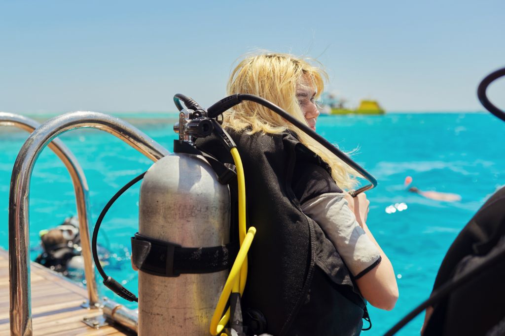 Young woman diver preparing for dive